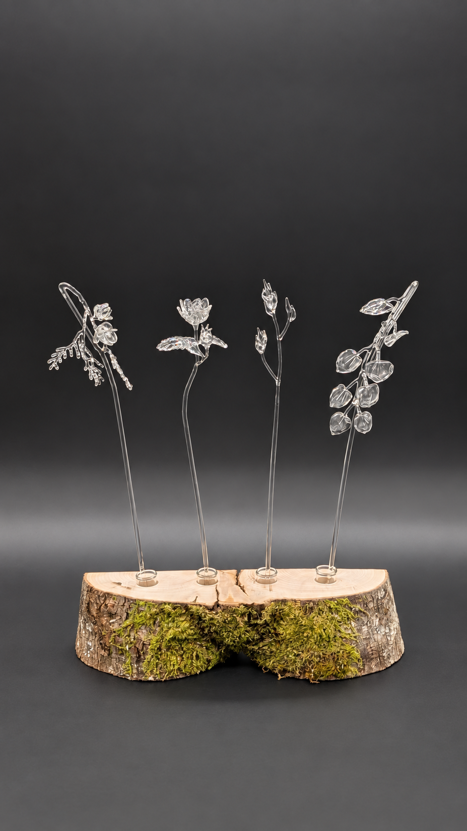 Art into Air installation with four clear-glass scent wands set into a moss-covered wood base