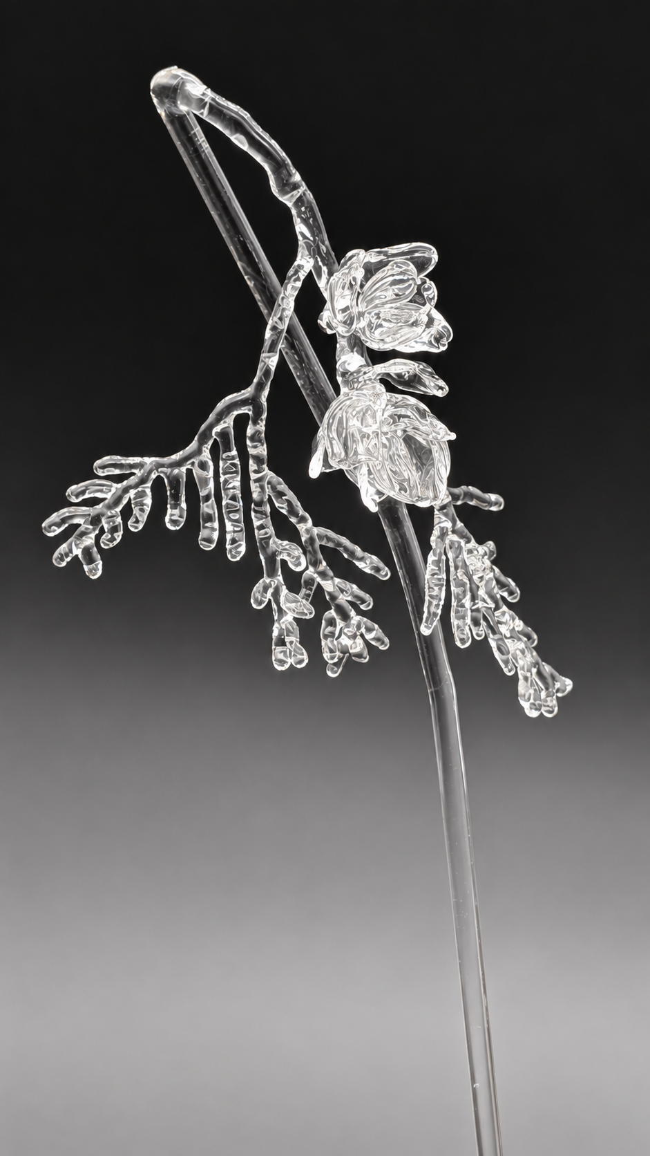 Clear-glass Forest After Trestle wand with a cedar branch and pine cones made by Stephanie Tayengco